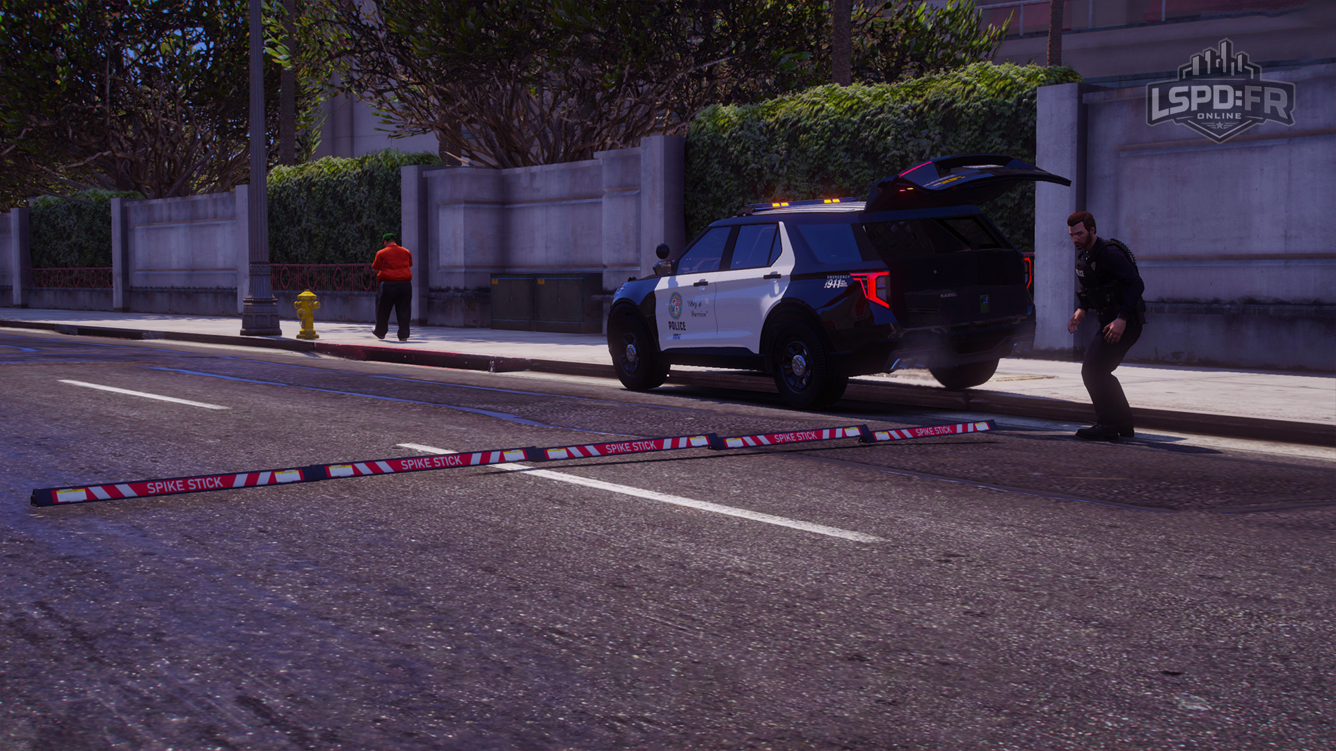 Deployed spike strip extending across two lanes of a roadway