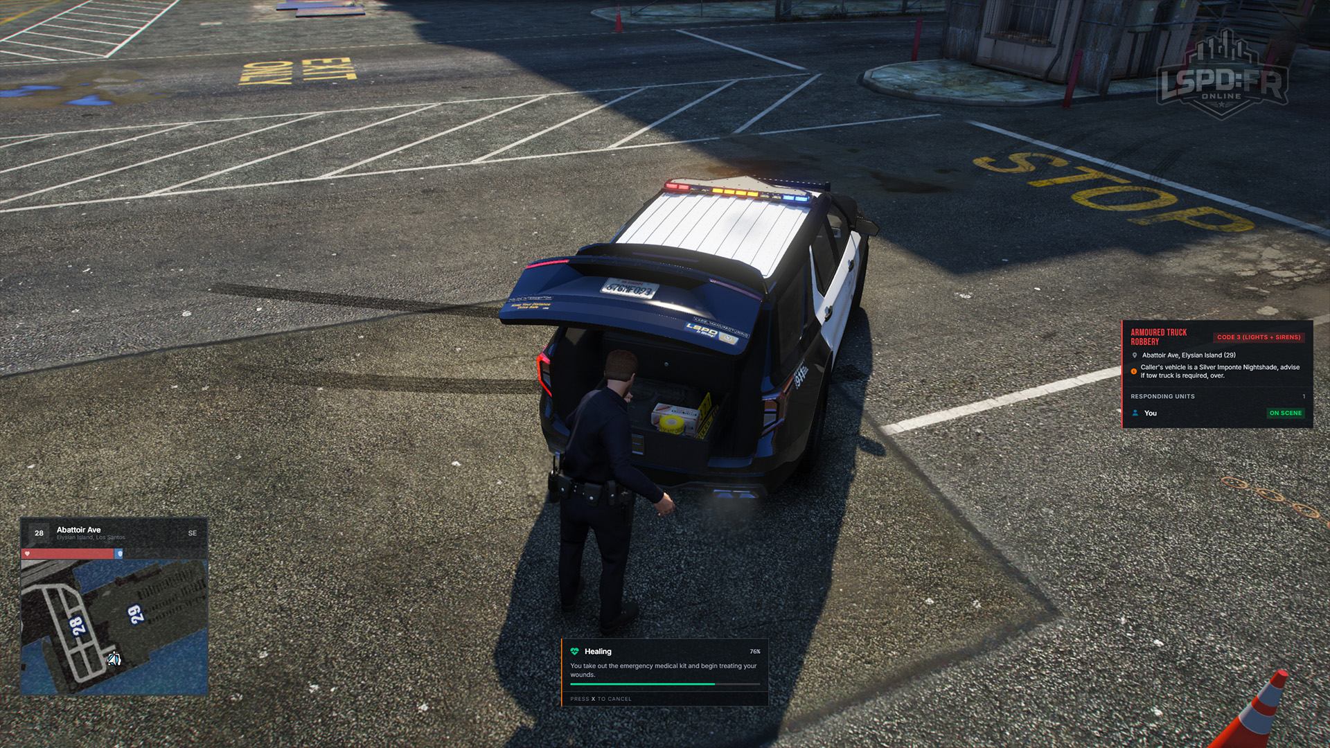 An officer healing at the trunk of their patrol vehicle